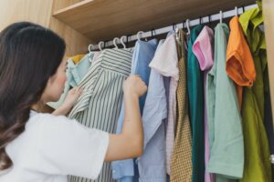 Woman looking through her closet to see what she needs from the Goodwill thrift shop in Edmonton